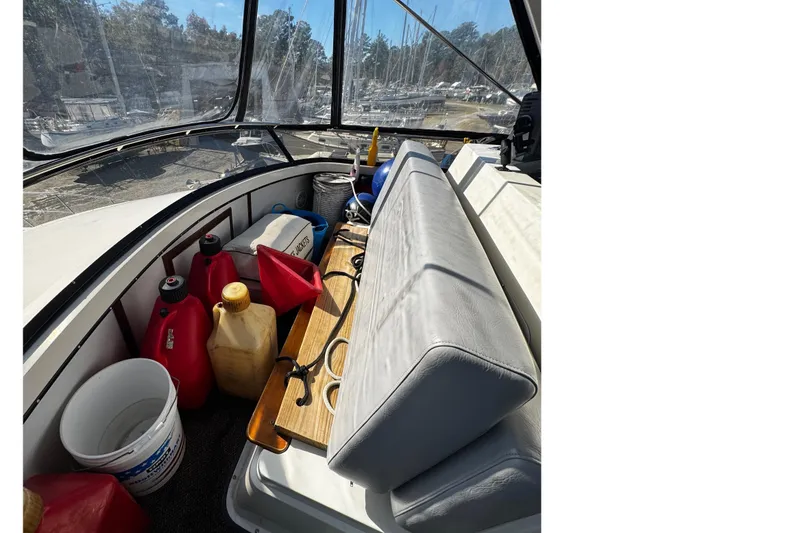 Slide: The Image of 1986 Carver 42 Aft Cabin Motor Yacht interior with seating and storage containers. - 26