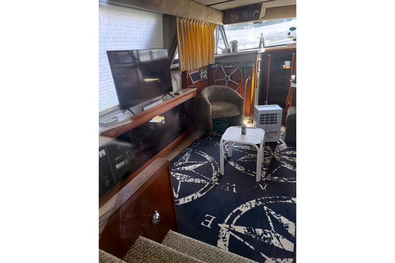 Slide: The Image of Interior of 1986 Carver 42 Aft Cabin Motor Yacht with TV and seating area. - 27