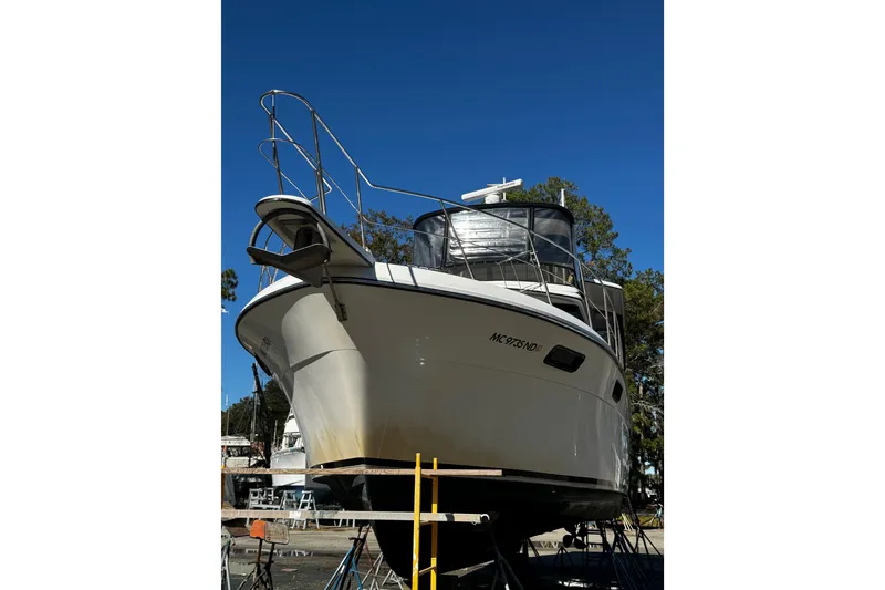 Slide: The Image of 1986 Carver 42 Aft Cabin Motor Yacht on dry dock under clear blue sky. - 4