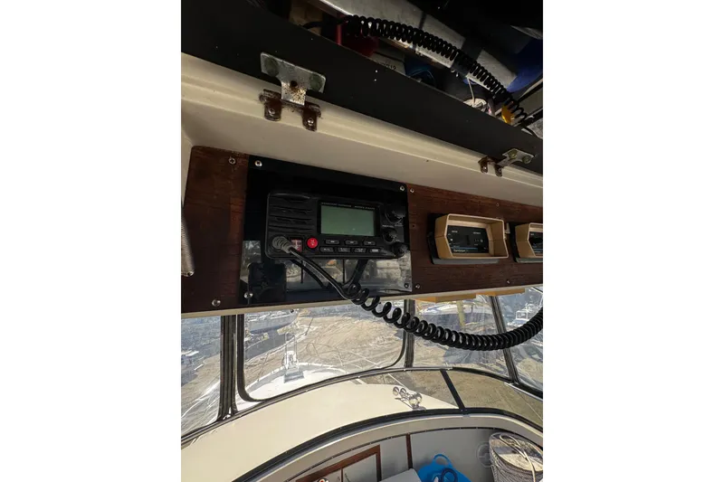 Slide: The Image of Interior view from 1986 Carver 42 Aft Cabin Motor Yacht, showing marina and trees outside. - 42