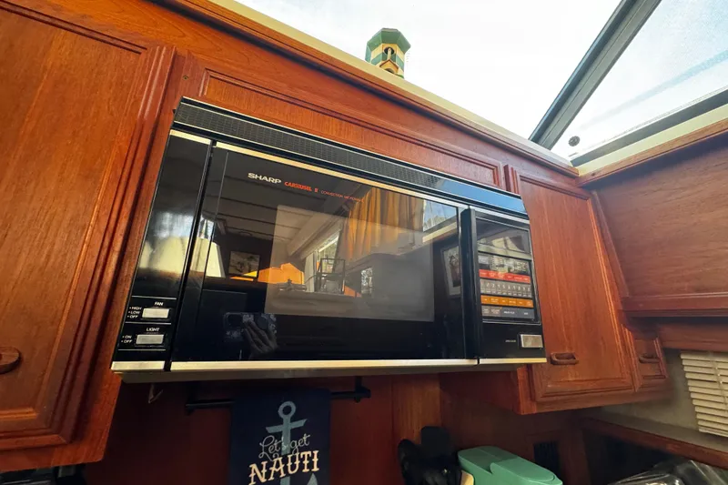 Slide: The Image of V-berth , ample storage , Cozy bedroom in 1986 Carver 42 Aft Cabin Motor Yacht with nautical decor. - 80