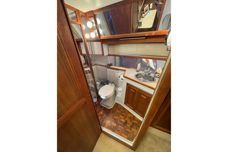 Slide: The Image of 1986 Carver 42 Aft Cabin Motor Yacht spacious galley with wood cabinetry and parquet flooring. - 91