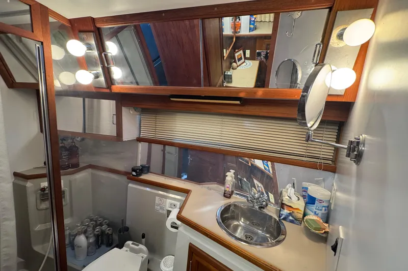 Slide: The Image of full size refrigerator inside 1986 Carver 42 Aft Cabin Motor Yacht, showcasing interior shelves. - 93