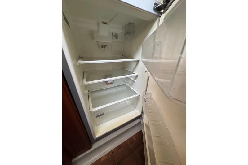 Slide: The Image of 1986 Carver 42 Aft Cabin Motor Yacht bedroom with cozy decor and mirrored closet. - 100