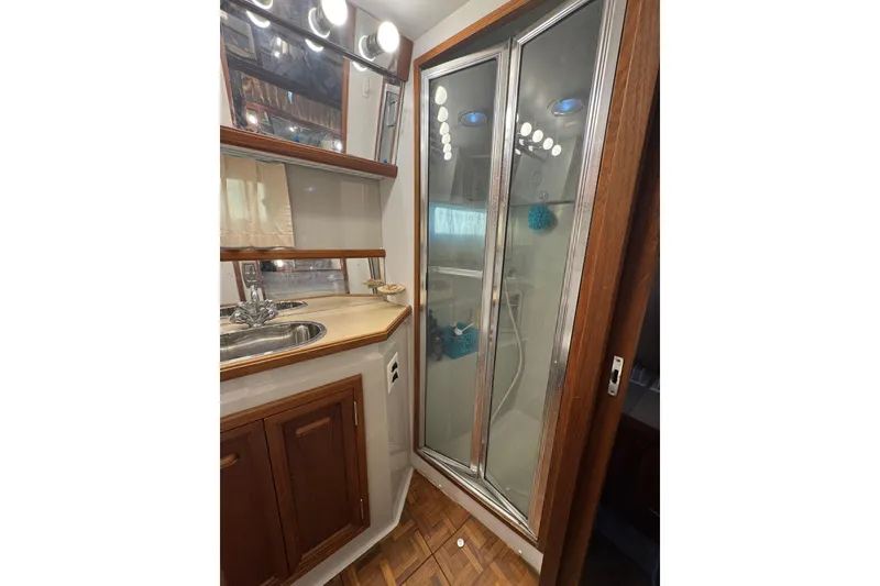 Slide: The Image of 1986 Carver 42 Aft Cabin Motor Yacht interior with generator and wooden cabinetry. - 110