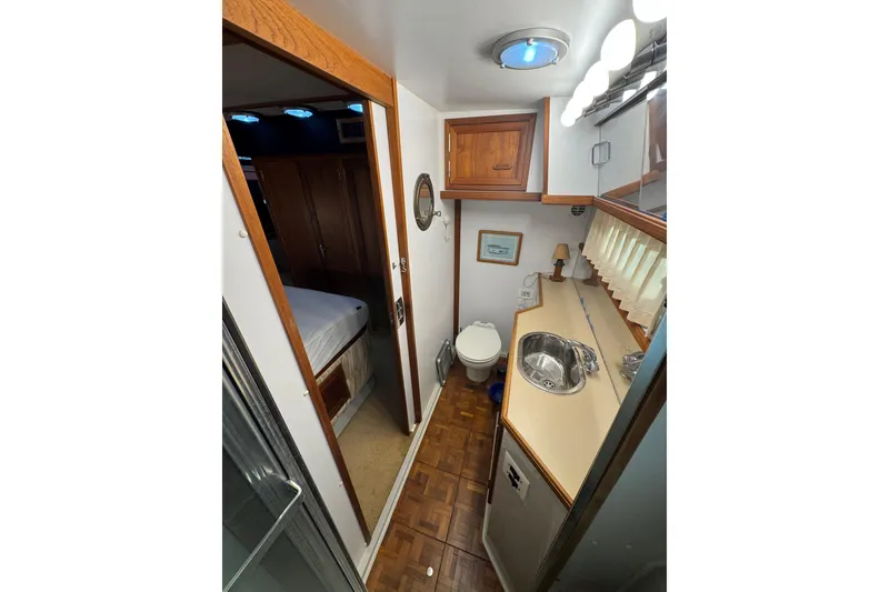 Slide: The Image of Engine room of 1986 Carver 42 Aft Cabin Motor Yacht, featuring blue engine components. - 112