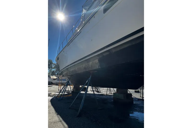 Slide: The Image of 1986 Carver 42 Aft Cabin Motor Yacht on stands under bright sunlight. - 20