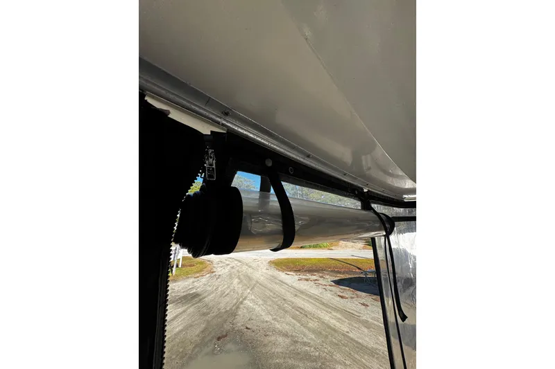 Slide: The Image of fully enclosed rear salon deck with seating space, storage area , and shown entry to lower main salon - 45