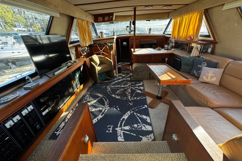 Slide: The Image of 1986 Carver 42 Aft Cabin Motor Yacht interior helm with wooden steering wheel and control panel. - 60