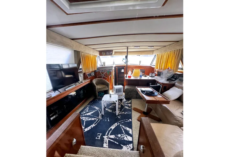 Slide: The Image of 1986 Carver 42 Aft Cabin Motor Yacht on dry dock under clear blue sky. - 7