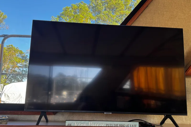 Slide: The Image of 1986 Carver 42 Aft Cabin Motor Yacht galley with appliances and wooden cabinetry. - 75