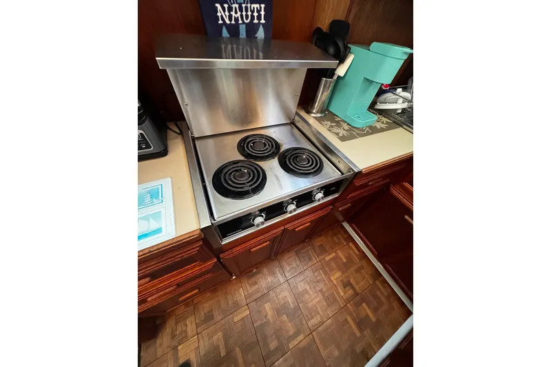 Slide: The Image of 1986 Carver 42 Aft Cabin Motor Yacht spacious galley with wood cabinetry and modern appliances. - 78