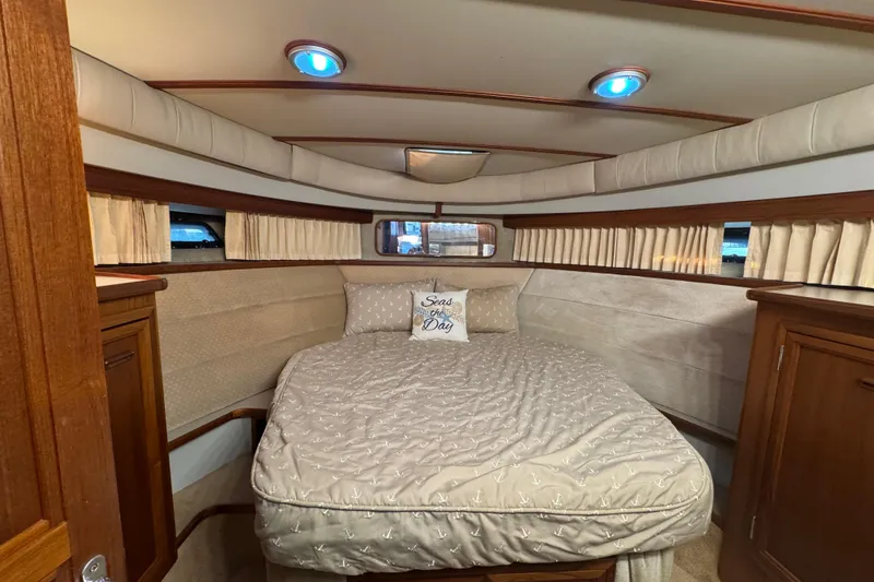 Slide: The Image of 1986 Carver 42 Aft Cabin Motor Yacht bathroom with sink, mirror, and toiletries. - 86