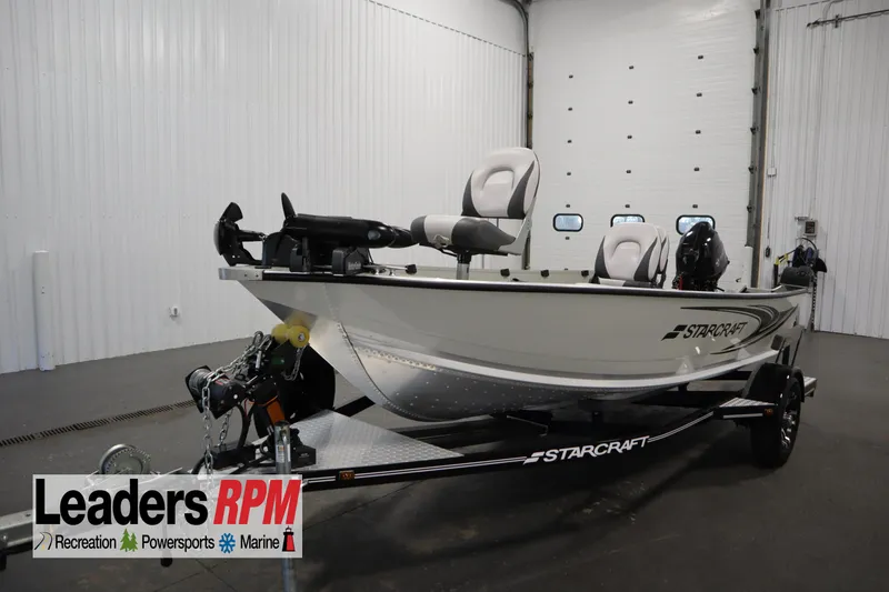 Slide: The Image of 2024 Starcraft Patriot 14 TL boat on trailer in indoor showroom. - 1