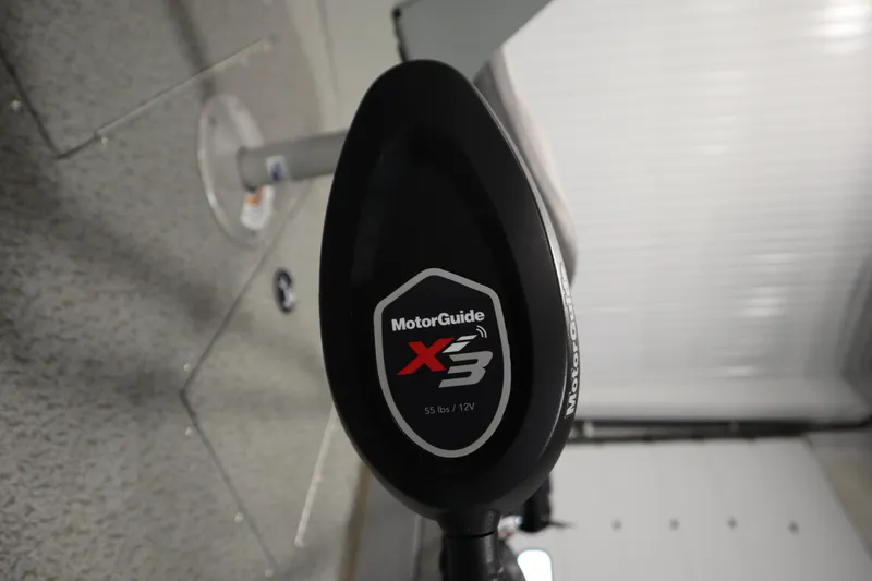 Slide: The Image of MotorGuide X3 motor on 2024 Starcraft Patriot 14 TL boat, indoor setting. - 12
