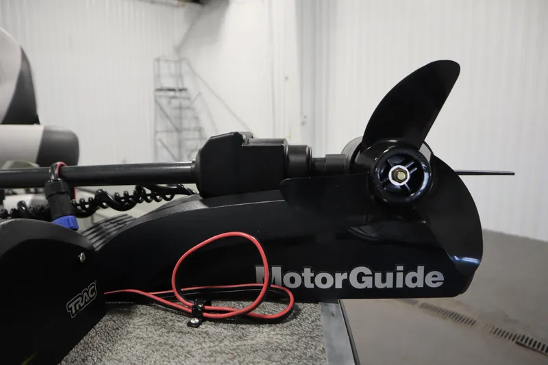 Slide: The Image of 2024 Starcraft Patriot 14 TL with MotorGuide trolling motor in a garage setting. - 13