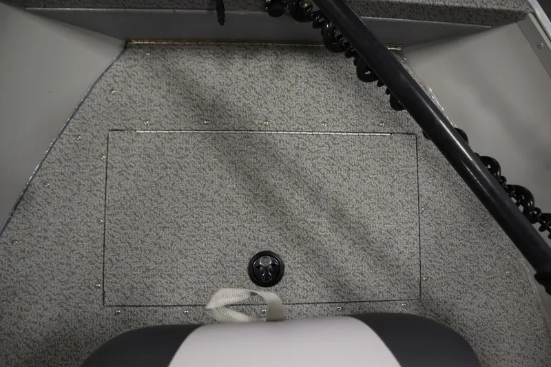 Slide: The Image of 2024 Starcraft Patriot 14 TL boat interior with textured flooring and storage compartment. - 15