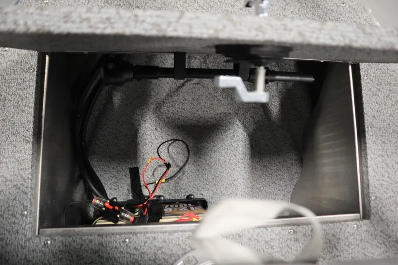 Slide: The Image of 2024 Starcraft Patriot 14 TL boat storage compartment with wiring and battery. - 16