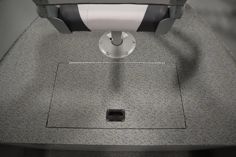 Slide: The Image of 2024 Starcraft Patriot 14 TL boat interior with gray carpet and seat. - 18