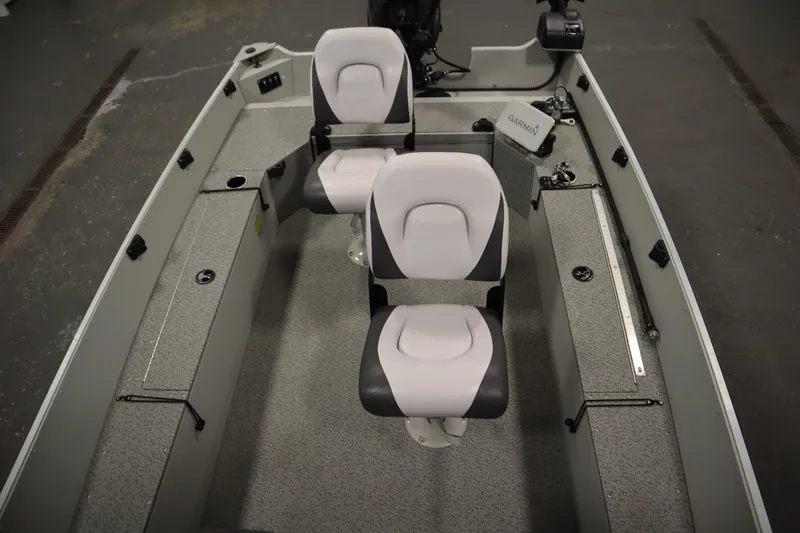 Slide: The Image of 2024 Starcraft Patriot 14 TL boat interior with two seats and storage compartments. - 20