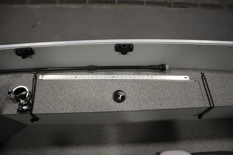 Slide: The Image of 2024 Starcraft Patriot 14 TL boat interior with measuring ruler and storage compartment. - 21