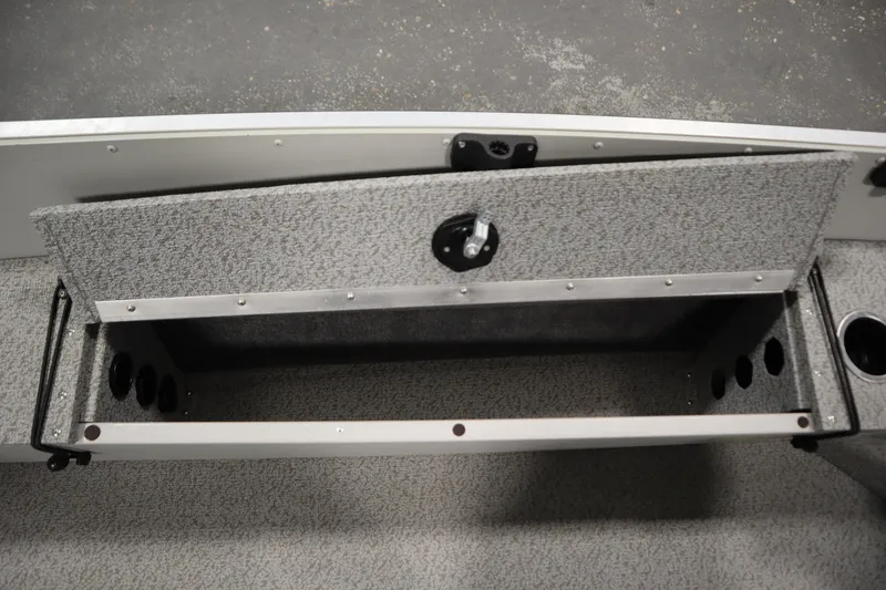 Slide: The Image of 2024 Starcraft Patriot 14 TL boat storage compartment with textured interior and cup holders. - 24