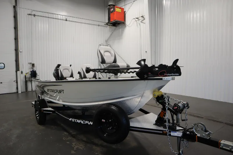 Slide: The Image of 2024 Starcraft Patriot 14 TL boat in a garage, featuring a MotorGuide trolling motor. - 3