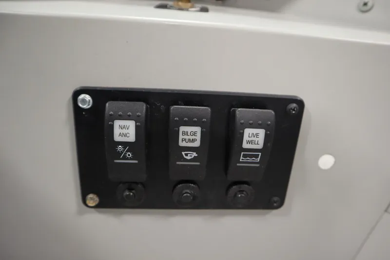 Slide: The Image of Control panel of 2024 Starcraft Patriot 14 TL with switches for navigation, bilge pump, and live well. - 30