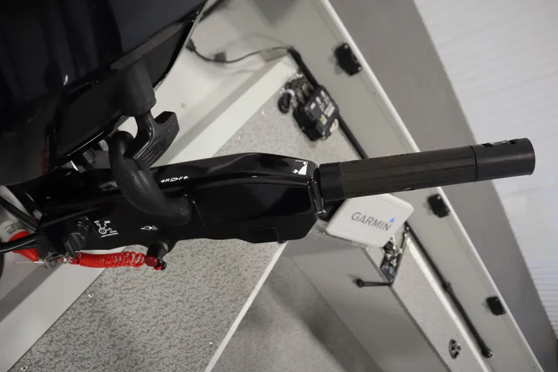 Slide: The Image of 2024 Starcraft Patriot 14 TL boat interior with Garmin equipment and motor controls. - 31