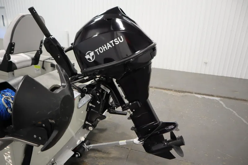 Slide: The Image of 2024 Starcraft Patriot 14 TL boat with Tohatsu outboard motor in a garage setting. - 34