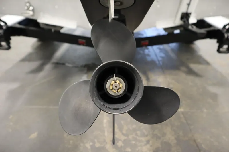 Slide: The Image of 2024 Starcraft Patriot 14 TL boat propeller close-up in a garage setting. - 37