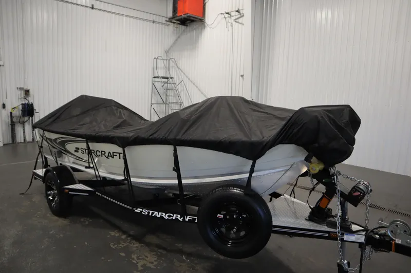 Slide: The Image of 2024 Starcraft Patriot 14 TL boat covered on trailer in indoor storage. - 43