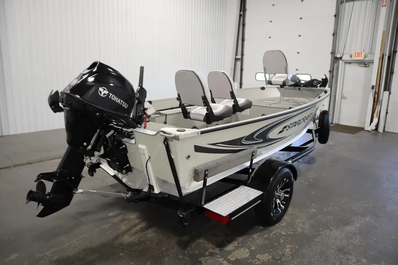 Slide: The Image of 2024 Starcraft Patriot 14 TL boat with Tohatsu motor in a garage setting. - 5