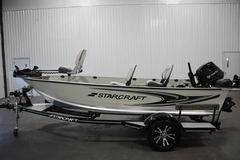 Slide: The Image of 2024 Starcraft Patriot 14 TL boat on trailer in indoor setting. - 8