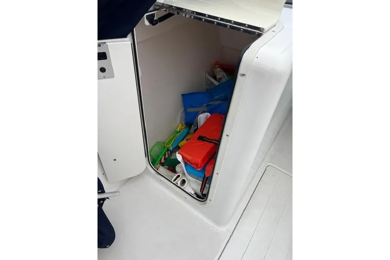 Slide: The Image of Storage compartment on a 2007 Sea Hunt Escape 220 boat with various boating gear. - 12