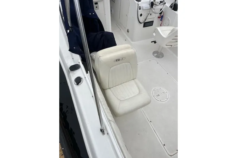 Slide: The Image of 2007 Sea Hunt Escape 220 boat interior with white seating and steering area. - 6