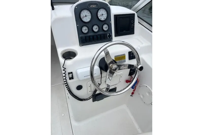 Slide: The Image of Steering console of 2007 Sea Hunt Escape 220 boat with gauges and controls. - 7