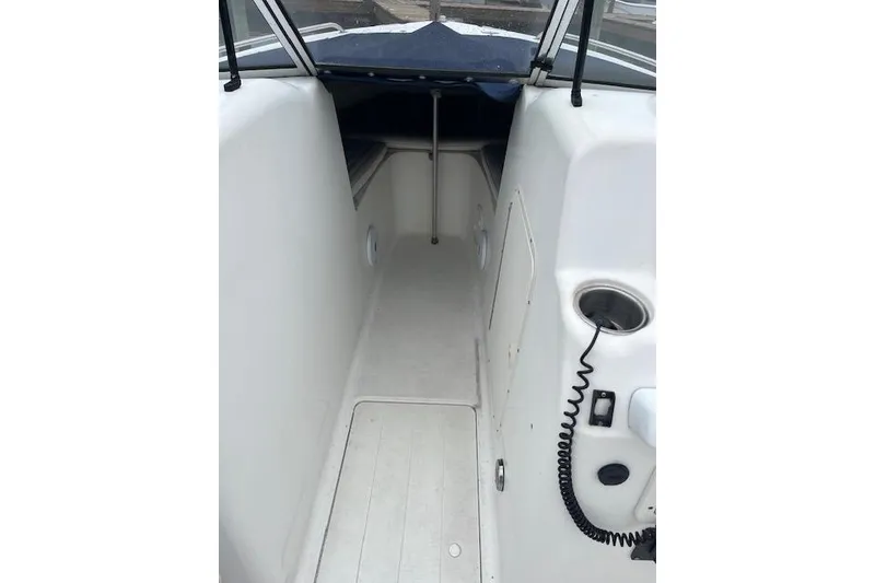 Slide: The Image of 2007 Sea Hunt Escape 220 boat interior with white seating and cup holder. - 8