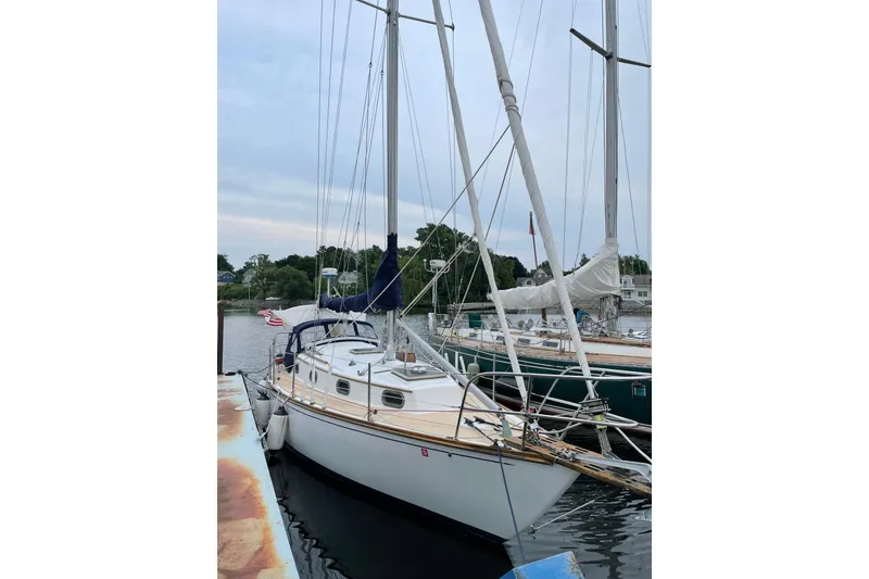 The Image of 1981 Cape Dory 30 sailboat docked at a marina, featuring classic design and rigging. - 1
