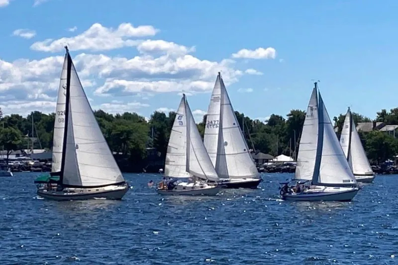 Slide: The Image of Sailboats on a sunny day, featuring a 1981 Cape Dory 30 model. - 12