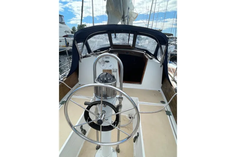 Slide: The Image of 1981 Cape Dory 30 sailboat cockpit with steering wheel and navigation instruments. - 5