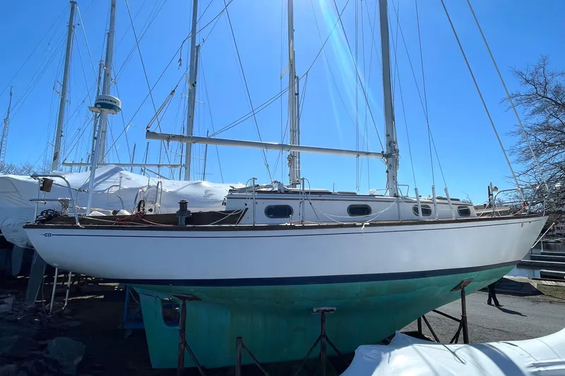 Slide: The Image of 1981 Cape Dory 30 sailboat on land, blue sky background. - 8