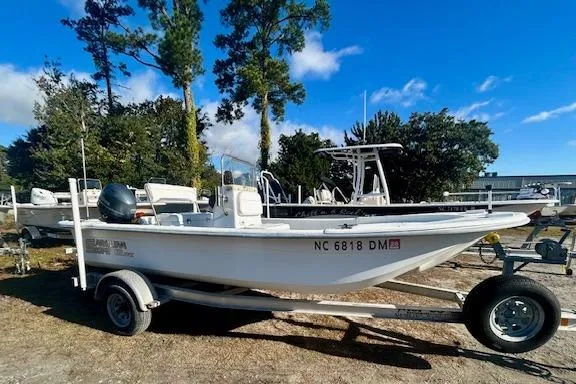 Slide: The Image of 2009 Carolina Skiff JVX18CC boat on trailer, parked outdoors under blue sky. - 1