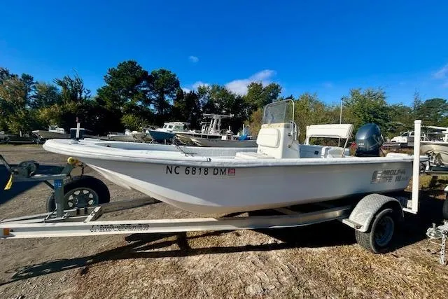 Slide: The Image of 2009 Carolina Skiff JVX18CC boat on trailer, parked outdoors under clear blue sky. - 3