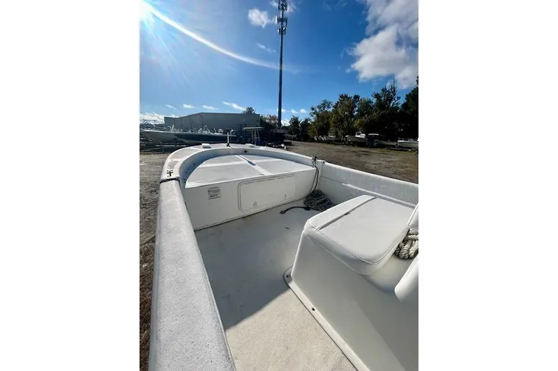 Slide: The Image of 2009 Carolina Skiff JVX18CC boat interior under sunny sky, parked outdoors. - 5