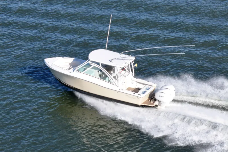 Slide: The Image of 2022 Albemarle 27 DC boat cruising on a sunny day in open water. - 10