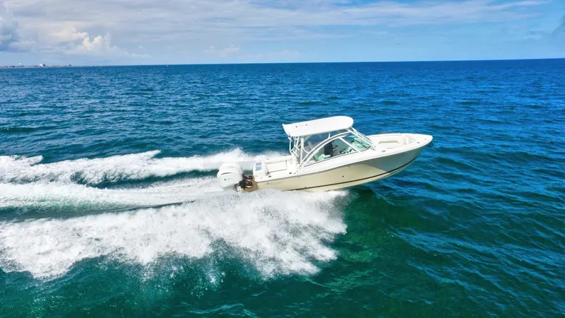 Slide: The Image of 2022 Albemarle 27 DC boat cruising on open ocean under clear blue sky. - 14