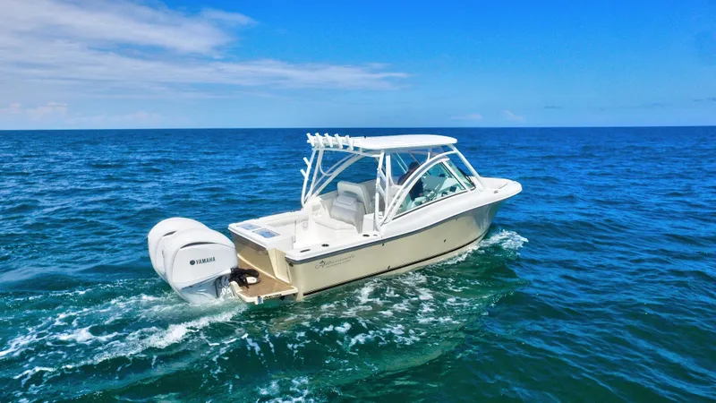 Slide: The Image of 2022 Albemarle 27 DC boat cruising on open ocean under clear blue sky. - 16