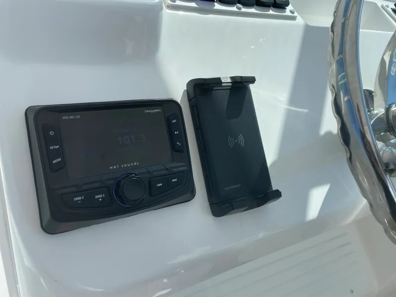 Slide: The Image of Control panel of 2022 Albemarle 27 DC boat with radio and phone holder. - 20