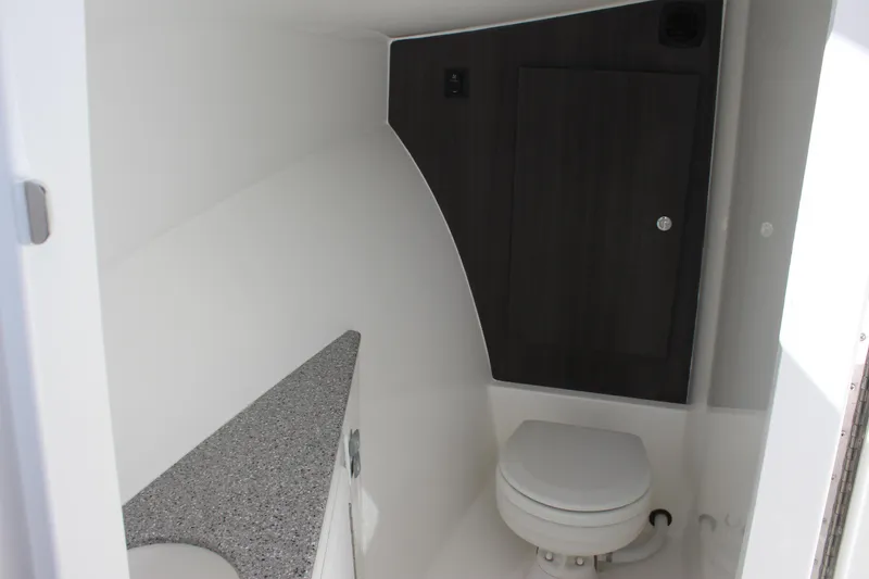 Slide: The Image of 2022 Albemarle 27 DC boat interior bathroom with toilet and countertop. - 27